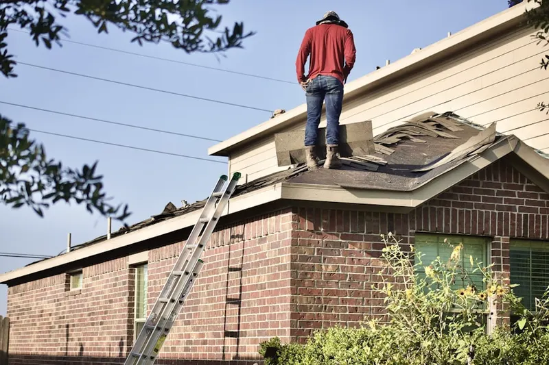 Professional roofer working on a residential roof in Occoquan